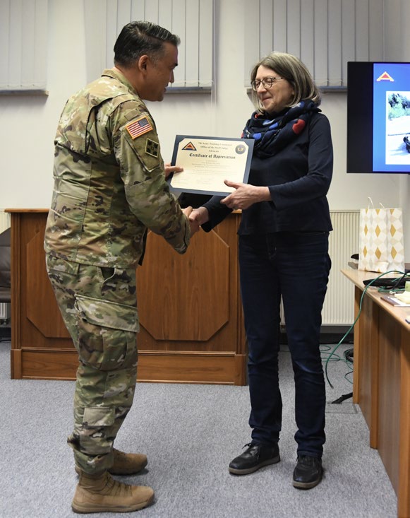 LTC Mel L. Williams, staff judge advocate,
            7th Army Training Command (7ATC),
            presents a certificate of appreciation to Ms.
            Waltraud Bayerlein, vice president of the
            Higher Regional Court of Nuremberg, in
            Vilseck, Germany, after nearly a decade of
            partnership between the court and 7ATC.
            (Credit: SGT Collin Mackall)
